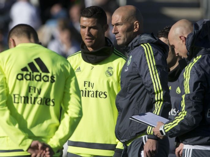 Real Madrid's newly appointed coach Zinedine Zidane, 3rd right stands next to Cristiano Ronaldo, 2nd left during his first training session in Madrid, Spain, Tuesday Jan. 5, 2016. Real Madrid fired coach Rafael Benitez Monday after seven months and replaced him with former player Zinedine Zidane a day after Madrid's 2-2 draw at Valencia deepened a crisis that started with an embarrassing 4-0 home loss to rival Barcelona in November. (AP Photo/Paul White)