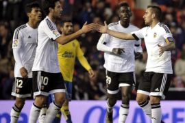 Valencia CF's striker Paco Alcacer (R) jubilates his goal against Las Palmas during their quarters finals first leg match of the Spanish King's Cup played at Mestalla stadium in Valencia, eastern of Spain on 21 January 2016.
