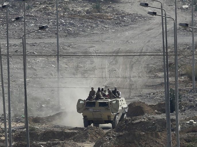 An Egyptian military vehicle patrols on Egypt's side of the border with southern Gaza Strip, near Rafah in the Gaza Strip, 02 July 2015. Security forces in Egypt's restive Sinai Peninsula have been targeted on 01 July in a spate of audacious attacks that analysts said marked an unprecedented tactic by a local Islamic State affiliate. There were conflicting reports about casualties from the synchronized attacks on security checkpoints and military facilities in the town of Sheikh Zuweid in northern Sinai. The military said that 'terrorist groups' attacked a number of positions in the Sheikh Zuweid and Rafah areas at 6.55 am local time (0455 GMT) on 01 July.