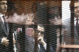(FILE) A file photo dated 09 May 2015 shows former Egyptian President, Hosni Mubarak (C), flanked by his sons Gamal Mubarak (L) and Alaa Mubarak (R), waving from the defendants' cage during their trial at the Police Academy in Cairo, Egypt. Egypt's highest appeals court on 04 June ordered a retrial for former president Mubarak on charges relating to the deaths of protesters, after granting an appeal by the prosecution. The Court of Cassation set November 5 for the start of the retrial of Mubarak, former interior minister Habib al-Adly and six former police chiefs in the same case.