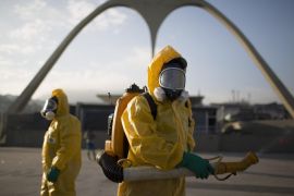 A health worker stands in the Sambadrome as he sprays insecticide to combat the Aedes aegypti mosquitoes that transmits the Zika virus in Rio de Janeiro, Brazil, Tuesday, Jan. 26, 2016. Inspectors begin to spray insecticide around Sambadrome, the outdoor grounds where thousands of dancers and musicians will parade during the city's Feb. 5-10 Carnival celebrations. Brazil's health minister says the country will mobilize some 220,000 troops to battle the mosquito blamed for spreading a virus linked to birth defects. (AP Photo/Leo Correa)