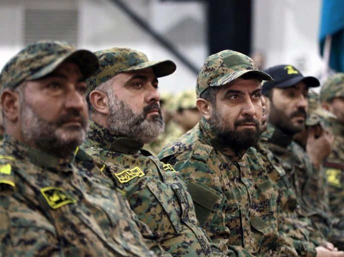 FILE - In this Wednesday, Nov. 11, 2015 file photo, Hezbollah fighters listen to Hezbollah leader Sheik Hassan Nasrallah, as he speaks via a video link during a rally to mark the Hezbollah martyr day, in the southern suburb of Beirut, Lebanon. At tightly guarded facilities in south Lebanon, men as young as 17 undergo intensive training on how to use automatic rifles and heavy machine guns before being shipped off to Syria to fight alongside President Bashar Assad's forces. The training is part of a massive Hezbollah recruitment effort to make up for its human losses in Syria's war, now approaching the death toll incurred by the group during 18 years of fighting Israeli occupation.(AP Photo/Bilal Hussein, File)
