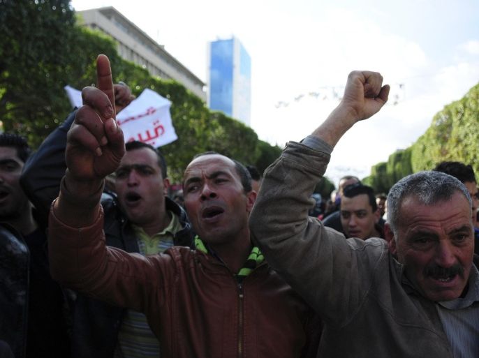 Unemployed tunisian people stage a protest in a precarious calm enforced by a nationwide curfew in Habib Bourguiba avenue, center downtown of Tunis, Saturday Jan. 23, 2016. Tunisia's president vowed Friday to end the cycle of unrest that has pummeled towns across the country as authorities imposed a nationwide curfew, five years after the nation, convulsed by protests, overthrew its longtime ruler and moved onto the road to democracy. (AP Photo/Riadh Dridi)