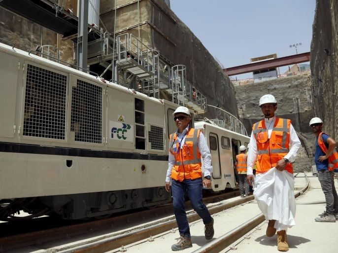 Workers walk at the site of the under-construction Riyadh Metro rail system in the Saudi capital Riyadh August 26, 2015. The project, which will involve six rail lines extending 176 kilometers (110 miles) and carrying electric, driverless trains, is the world's largest public transport system currently under development, Saudi officials said. REUTERS/Faisal Al Nasser