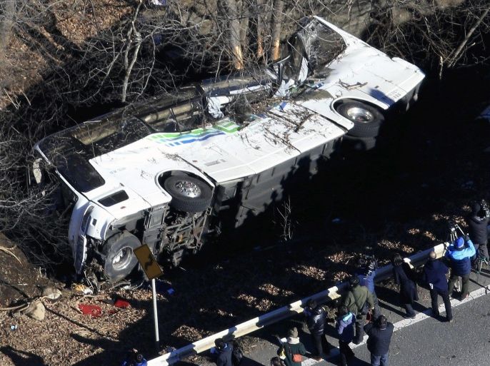 A general view of a crashed bus in Karuizawa, Nagano Prefecture, central Japan, 15 January 2016. Fourteen tourists were dead and 27 injured after a bus plunged off a road in central Japan early 15 January 2016. The bus carrying 39 passengers and two drivers veered off the road, breaking through the guard rail, authorities said. The accident occurred in Karuizawa town, 120 kilometres north-west of Tokyo. EPA/JUN YASUKAWA JAPAN OUT