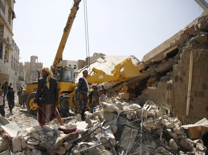 Policemen search for survivors at the site of a Saudi-led airstrike on the police headquarters in Sanaa, Yemen, Monday, Jan. 18, 2016. The police officials, who are loyal to anti-government Shiite rebels known as the Houthis, said many people are believed to be still trapped under the debris of the badly damaged building in central Sanaa. (AP Photo/Hani Mohammed)