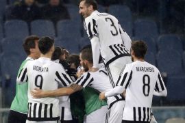 Juventus players celebrate after their teammate Stephan Lichtsteiner scored during an Italian Cup soccer match between Lazio and Juventus, at Rome's Olympic Stadium, Wednesday, Jan. 20, 2016. (AP Photo/Andrew Medichini)