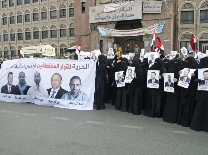 Women hold a banner and posters of activists, whom they say are being held by Houthi fighters, during an anti-Houthi demonstration in Sanaa March 4, 2015. Violence has spread and intensified in Yemen since the Iranian-backed Houthis captured the capital Sanaa on Sept. 21 and fanned out south and east seizing traditional Sunni areas. Yemen plunged deeper into political turmoil in January after the Houthis seized the presidential palace and forced the Western-backed President Abd-Rabbu Mansour Hadi and his government to resign. The banner (L) reads: "Freedom for the freedom seekers held hostage by the Houthi militia." REUTERS/Khaled Abdullah (YEMEN - Tags: POLITICS CIVIL UNREST CONFLICT)