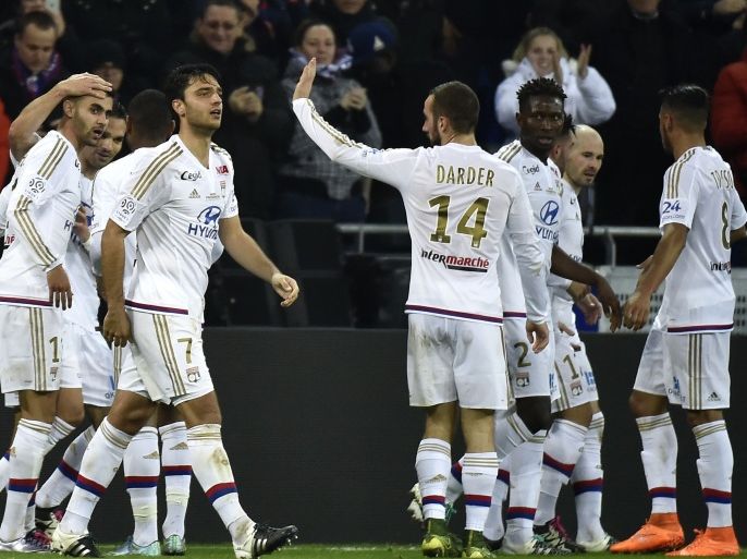 3234 - Décines-Charpieu, Rhône, FRANCE : Lyon's French Algerian midfielder Rachid Ghezzal (L) celebrates with his teammates after scoring during the French L1 football match Olympique Lyonnais (OL) vs Troyes on January 9, 2016, at the New Stadium in Decines-Charpieu, central-eastern France. AFP PHOTO / JEFF PACHOUD