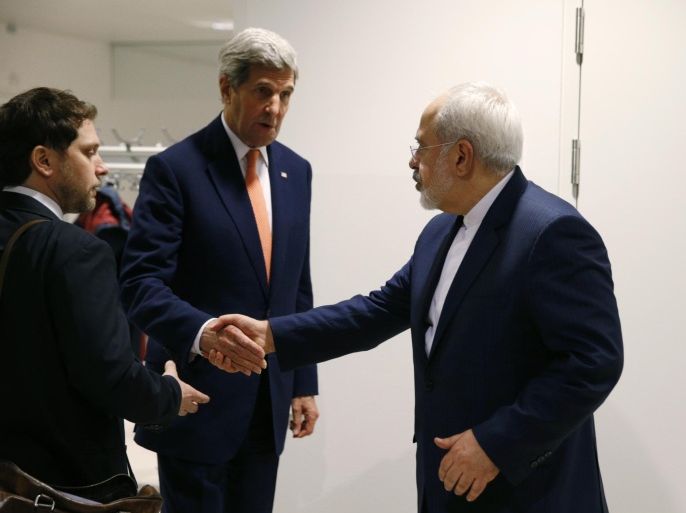 U.S. Secretary of State John Kerry shakes hands with Iranian Foreign Minister Mohammad Javad Zarif, right, after the International Atomic Energy Agency (IAEA) verified that Iran has met all conditions under the nuclear deal, in Vienna, Austria, Saturday Jan. 16, 2016. U.S. Secretary of State, John Kerry confirms Iran in compliance with nuclear deal and lifts US nuclear-related sanctions. (Kevin Lamarque/Pool via AP)