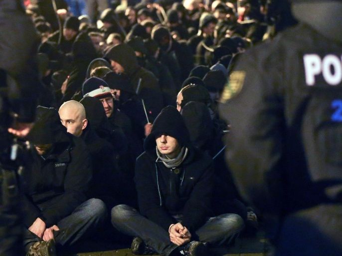 About 250 hooligans are encircled by the local police after riots following a demonstration of Leipzig's Europeans against the Islamization of the West (LEGIDA), a group linked with the PEGIDA movement, in Leipzig, eastern Germany, Monday, Jan. 11, 2016. in Leipzig. (Jan Woitas, DPA via AP)