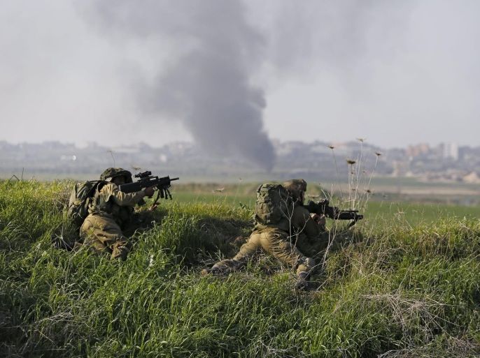 Israeli soldiers wait in position across from the Israeli-Gaza border in southern Israel January 13, 2016. An Israeli aircraft attacked a group of Palestinians in the Gaza Strip on Wednesday who the military said planned to detonate a bomb at the border with Israel, and a Palestinian militant faction said one of its men was killed. REUTERS/Amir Cohen