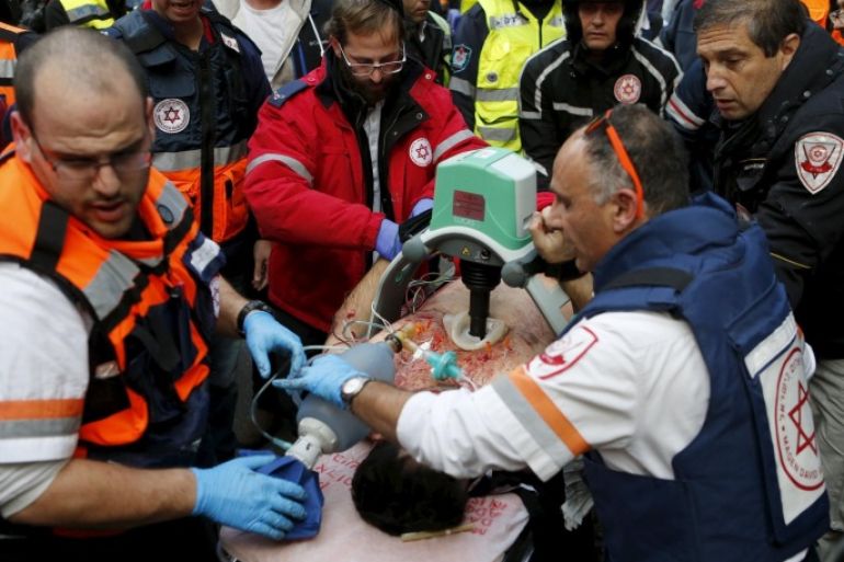 ATTENTION EDITORS - VISUAL COVERAGE OF SCENES OF INJURY OR DEATH Israeli medics evacuate a wounded person from the scene of a shooting incident in Tel Aviv, Israel January 1, 2016. One person was killed and several were wounded in a shooting incident in central Tel Aviv on Friday, Israeli media said. A police spokesman confirmed there had been several casualties but would not say if anyone was killed in the incident on Dizengoff Street. REUTERS/Nir Elias TEMPLATE OUT