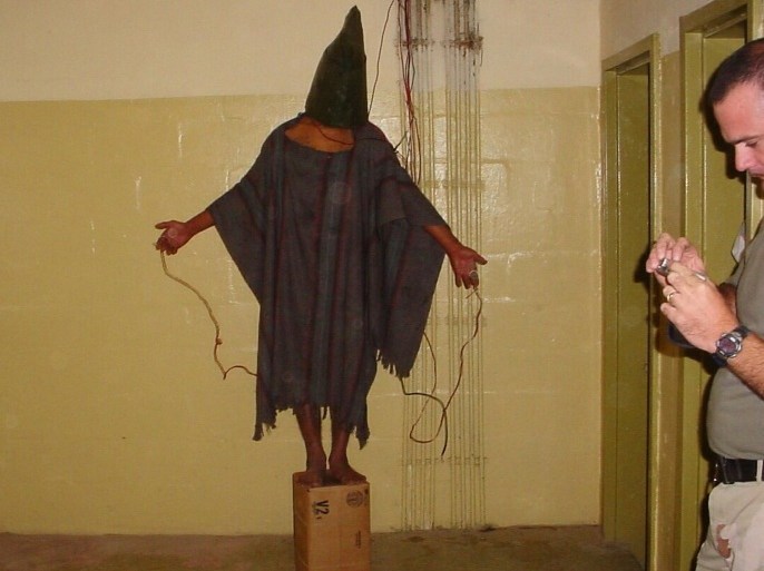 FILE - This late 2003 file photo, an image obtained by The Associated Press, shows an unidentified detainee standing on a box with a bag on his head and wires attached to him in the Abu Ghraib prison in Baghdad, Iraq. Amid violence like the attack in Paris on a satirical newspaper over its depictions of the Prophet Muhammad, there’s been increasing discussions among Muslims who say their community must re-examine their faith to modernize its interpretations and sideline extremists. Cherif Kouachi, one of the French brothers behind the Charlie Hebdo killings, appears to have been first radicalized by hearing of abuses of Iraqi inmates by American guards at Abu Ghraib prison. (AP Photo, File)
