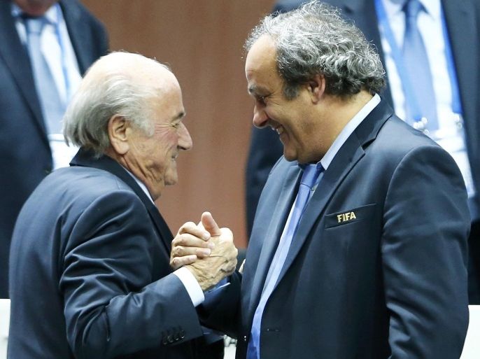 File picture of UEFA President Michel Platini (R) congratulating FIFA President Sepp Blatter after he was re-elected at the 65th FIFA Congress in Zurich, Switzerland, May 29, 2015. Suspended FIFA President Blatter and European soccer boss Platini were both banned for eight years December 21, 2015 by FIFA's Ethics Committee. The pair, who have also been fined, had been suspended for 90 days in October while an investigation was carried out into a 2 million Swiss franc ($2.02 million) payment by FIFA to Platini in 2011. Both men have denied any wrongdoing. REUTERS/Arnd Wiegmann TPX IMAGES OF THE DAY