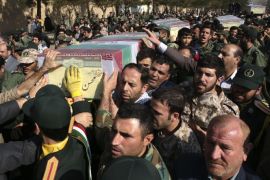 Civilians and armed forces members carry the flag draped coffins of Iranian Revolutionary Guard Gen. Mohsen Ghajarian, foreground, and five soldiers who were killed in fighting in Syria, during their funeral ceremony outside the headquarters of the guard's ground forces, in Tehran, Iran, Saturday, Feb. 6, 2016. The six soldiers were killed while fighting alongside President Bashar Assad's forces in northern Syria while battling the Islamic State group and Syrian rebels. (AP Photo/Vahid Salemi)