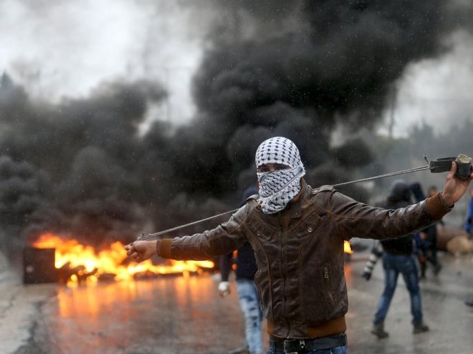 A Palestinian protester prepares his sling to hurl stones towards Israeli troops during clashes in the West Bank town of Qabatya, near Jenin February 6, 2016. On Wednesday, three young Palestinian men from Qabatya wielding guns, knives and pipe-bombs killed a paramilitary Israeli policewoman in Jerusalem and were shot dead. In response, Israeli forces raided the assailants' hometown, arresting five suspected militants and imposing a closure. REUTERS/Mohamad Torokman TPX IMAGES OF THE DAY