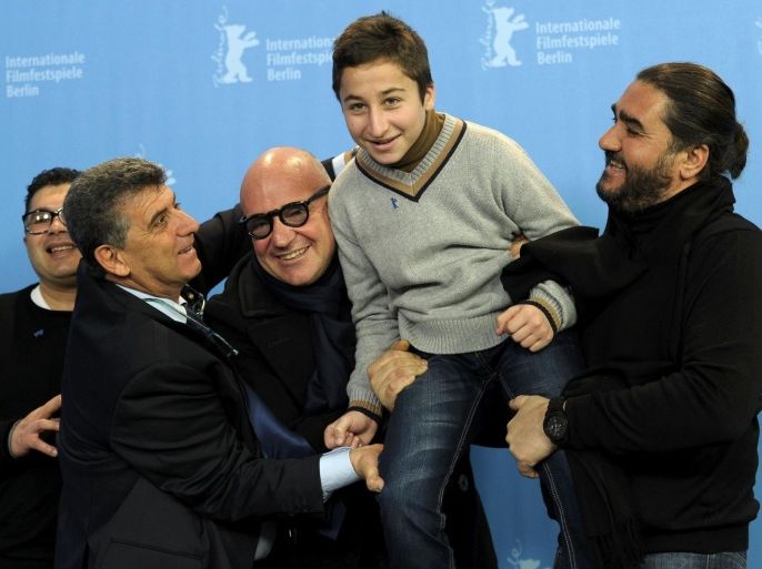 Giuseppe Fragapane, Pietro Bartolo, director Gianfranco Rosi, Samuele Pucillo and Giuseppe del Volgo (L-R) pose during a photocall to promote the movie 'Fuocoammare' (Fire at Sea) at the 66th Berlinale International Film Festival in Berlin, Germany February 13, 2016. REUTERS/Stefanie Loos