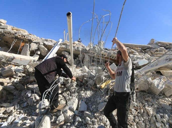 People look for survivors in the ruins of a destroyed Medecins Sans Frontieres (MSF) supported hospital hit by missiles in Marat Numan, Idlib province, Syria, February 16, 2016. REUTERS/Ammar Abdullah