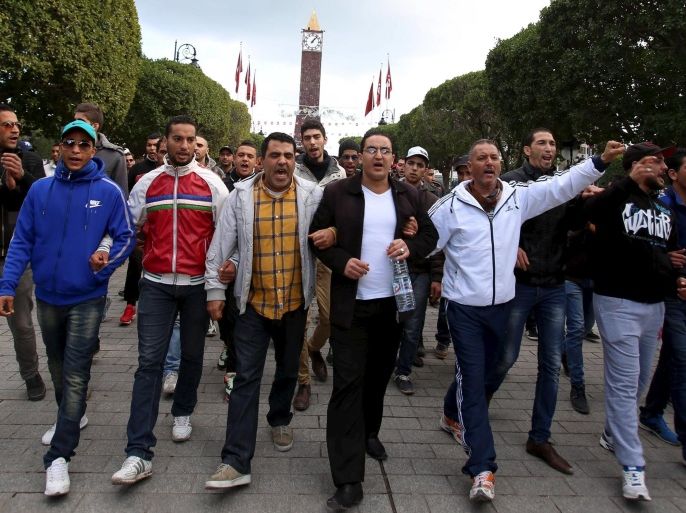 Unemployed graduates shout slogans during a demonstration to demand the government provide them with job opportunities, on Habib Bourguiba Avenue in Tunis, Tunisia January 22, 2016. There were further demonstrations on Friday in several regions, including Kasserine and Sidi Bouzid. In Tunis, demonstrators blocked a major thoroughfare and burned tyres in the street. At least 19 people were arrested in the capital in connection with the unrest, a security official said. REUTERS/Zoubeir Souissi