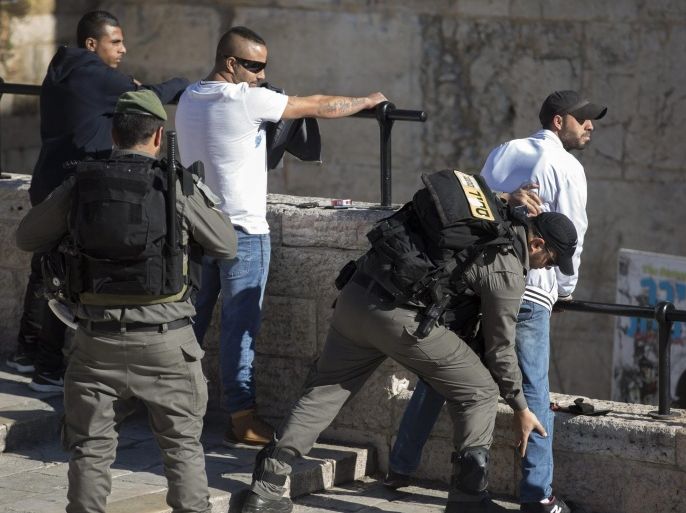 Israeli Border Police frisk Palestinian men just outside the Damascus Gate and the Old City walls (behind) in Arab East Jerusalem, Israel, 04 February 2016. On 03 February, three Israeli Border Police women were stabbed and one died from her wounds in a attack by three Palestinians from the West Bank armed with an automatic weapon, knives and explosives. Israel continues with a strong security presence in the Old City with frequent body searches carried on on Palestinian young men.