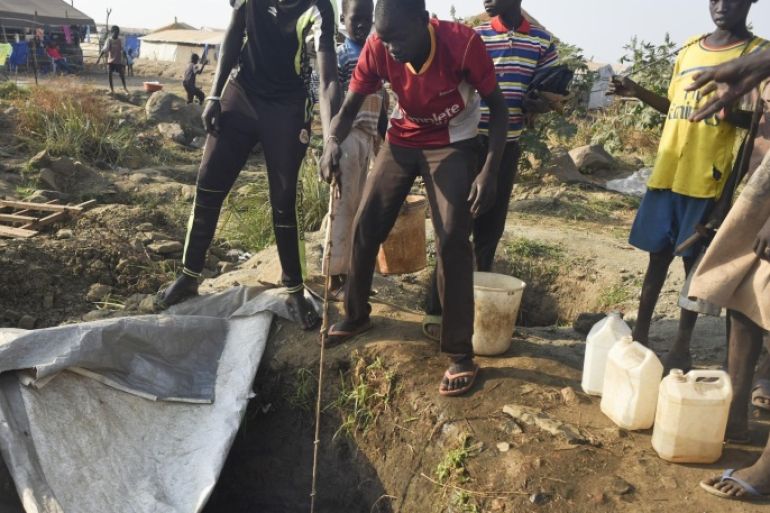 In this photo taken Tuesday, Jan. 19, 2016, displaced people draw water from a hole dug in the ground, in the United Nations camp for displaced people in the capital Juba, South Sudan. When a delegation of South Sudanese rebels returned to the government-controlled capital Juba last month after two years of war, many refugees thought they would finally return to the homes they fled. But prospects for peace seem dim after the government and rebels missed a deadline last week to form a power-sharing government and end the war. Photo/Jason Patinkin)