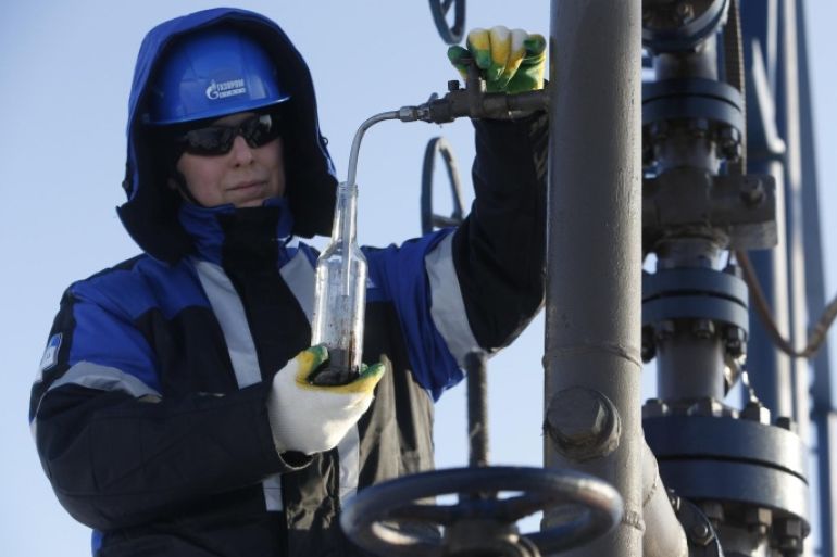 A worker takes oil samples from a well at the Gazpromneft company owned Yuzhno-Priobskoye oil field outside the West Siberian city of Khanty-Mansiysk, Russia, January 28, 2016. Picture taken January 28, 2016. REUTERS/Sergei Karpukhin