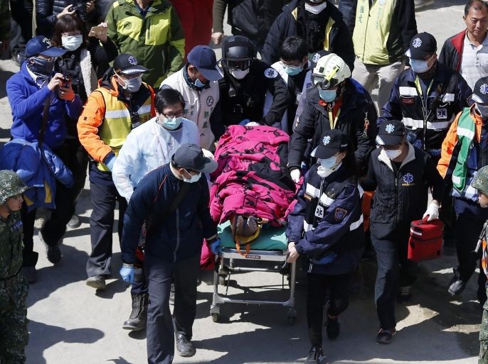 Rescuers assist a male survivor on a stretcher after being rescued from a collapsed building following the 06 February 6.4 magnitude earthquake, in Tainan City, southern Taiwan, 08 February 2016. More than 100 people were missing after a 6.4-magnitude earthquake killed at least 34 in southern Taiwan, authorities said.