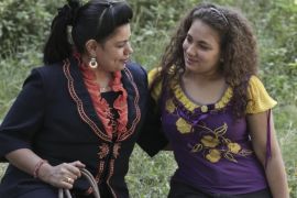 In this Saturday, Nov. 15, 2014 photo, Egyptian Coptic Christian Manal Nasef Fahmy, 35, poses for a photograph with her 17-year-old daughter Marina, who were both subjected to female genital mutilation in Sidfa, 340 kilometers (210 miles) south of Cairo, Egypt. "The midwife came to our home. My father took me far away so I don't hear my older sister screaming as she underwent the operation. I was next after my sister and I will never forget it," she said. Manal had a doctor circumcise her daughter Marina without anesthesia. "I decided to have her circumcised before being educated about it. I will always regret it," Manal said. (AP Photo/Nariman El-Mofty)