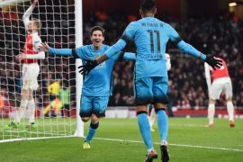 Barcelona's Lionel Messi (C) celebrates after scoring the 0-1 goal during the UEFA Champions League Round of 16 first leg soccer match between Arsenal and Barcelona at the Emirates Stadium in London, Britain, 23 February 2016.