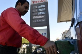 An employee pumps fuel in to a vehicle in front a bill board that shows the price of standard gasoline in Beirut, Lebanon, 09 February 2016. Media reports said the Lebanese Cabinet will discuss during a meeting on 10 February adding 5,000 LBP (three euros) tax on every 20 liters of fuel in an attempt to relieve pressure on the budget and deficit in Lebanon. Standard gasoline is sold at 20,200 Lebanese Pounds (LBP) (about 12 Euros) per 20 liter at gas stations. Unions threaten a general strike on 11 February if hike was approved by cabinet.