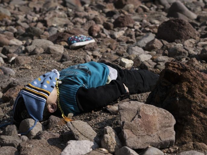 The lifeless body of a migrant boy lies on the beach near the Aegean town of Ayvacik, Canakkale, Turkey, Saturday, Jan. 30, 2016. A boat carrying migrants to Greece hit rocks off the Turkish coast on Saturday and capsized, killing at least 33 people, including five children, officials and news reports said. Some 75 other migrants were rescued. A Turkish government official said he expects the death toll from the incident to rise as rescue workers try to reach other migrants believed trapped inside the wreckage of the boat which sank shortly after departing from the Aegean resort of Ayvacik.(AP Photo/Halit Onur Sandal)