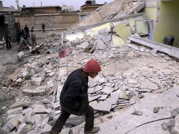 A boy inspects his school, damaged in what activists said was an air strike carried out yesterday by the Russian air force in Injara town, Aleppo countryside, Syria January 12, 2016. Bombs dropped by suspected Russian warplanes killed at least 12 Syrian schoolchildren on Monday when they hit a classroom in a rebel-held town in Aleppo province, the Syrian Observatory for Human Rights reported. REUTERS/Khalil Ashawi