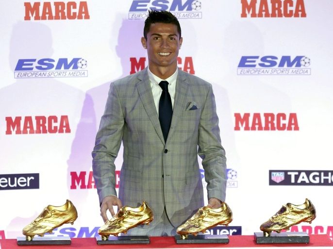 Real Madrid's Portuguese forward Cristiano Ronaldo poses with his four European Golden Shoe awards as Europe's best goal scorer of the 2014-2015 season in Madrid, Spain, 13 October 2015. He is the first player ever to receive a fourth Golden Shoe award.