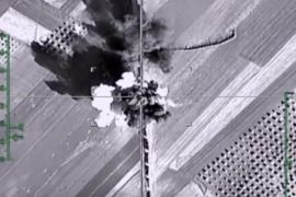 In this photo made from the footage taken from Russian Defense Ministry official web site on Monday, Feb. 1, 2016, an aerial image shows what it says is a column of heavy trucks carrying ammunition hit by a Russian air strike near Aleppo, Syria. The Russian military has beefed up its air group in Syria with state-of-the art fighter jets amid tensions with Turkey. (Russian Defense Ministry Press Service photo via AP)