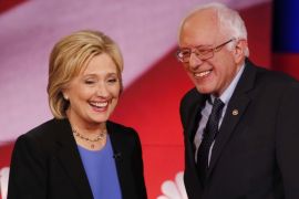 Democratic presidential candidate, Hillary Clinton and Democratic presidential candidate, Sen. Bernie Sanders, I-Vt. smile during a break of the NBC, YouTube Democratic presidential debate at the Gaillard Center, Sunday, Jan. 17, 2016, in Charleston, S.C. (AP Photo/Mic Smith)