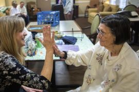 In this Nov. 16, 2015 photo, Dori Thompson, an art therapist who uses movement, painting and contact interaction to help people with dementia and other ailments, works with Betty Barnes, 95, at Bickford Senior Living in Peoria, Ill. (Fred Zwicky/Journal Star via AP)