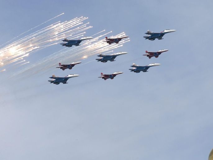 MiG-29 jet fighters of the Strizhi (Swifts) and Sukhoi Su-27 jet fighters of the Russkiye Vityazi (Russian Knights) aerobatic teams fly over the Kremlin, during the Victory Day military parade at the Red Square in Moscow, Russia, 09 May 2015. The Victory Day parade on 09 May 2015 marks the 70th anniversary since the capitulation of Nazi Germany.