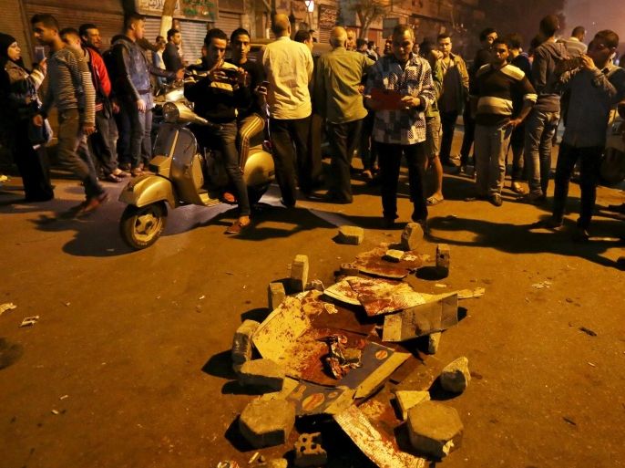 People gather near to blood stains beside the Cairo Security Directorate in Cairo, Egypt, February 18, 2016. Hundreds of protesters gathered in front of the Cairo security directorate on Thursday night after a policeman shot dead a man in the street, in the latest outburst of anger over alleged police brutality in Egypt. REUTERS/Mohamed Abd El Ghany