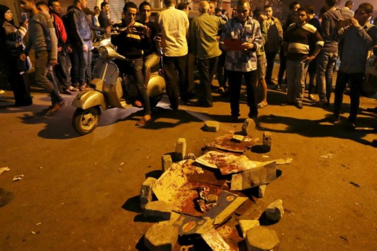 People gather near to blood stains beside the Cairo Security Directorate in Cairo, Egypt, February 18, 2016. Hundreds of protesters gathered in front of the Cairo security directorate on Thursday night after a policeman shot dead a man in the street, in the latest outburst of anger over alleged police brutality in Egypt. REUTERS/Mohamed Abd El Ghany