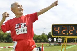 105-year-old Japanese Hidekichi Miyazaki poses like Jamaica's Usain Bolt in front of an electric board showing his 100-metre record time of 42.22 seconds at an athletic field in Kyoto, Japan, in this photo taken by Kyodo September 23, 2015. Japanese centenarian Hidekichi Miyazaki set a record as the world's oldest competitive sprinter this week, one day after turning 105, but said he was disappointed at falling short of his own personal best. Picture taken September 23, 2015. Mandatory credit REUTERS/Kyodo ATTENTION EDITORS - FOR EDITORIAL USE ONLY. NOT FOR SALE FOR MARKETING OR ADVERTISING CAMPAIGNS. THIS IMAGE HAS BEEN SUPPLIED BY A THIRD PARTY. IT IS DISTRIBUTED, EXACTLY AS RECEIVED BY REUTERS, AS A SERVICE TO CLIENTS. MANDATORY CREDIT. JAPAN OUT. NO COMMERCIAL OR EDITORIAL SALES IN JAPAN. TPX IMAGES OF THE DAY