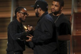 Kendrick Lamar (L) takes the stage to accept the award for Best Rap Album for "To Pimp A Butterfly" from presenters Ice Cube and O'Shea Jackson Jr. at the 58th Grammy Awards in Los Angeles, California February 15, 2016. Lamar celebrated his win by shouting out his mentors including hip-hop legend Snoop Dogg. REUTERS/Mario Anzuoni SEARCH â€œTOP 15 GRAMMYSâ€� FOR ALL IMAGES
