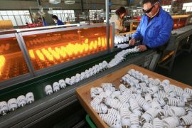 A photo made available 07 January 2016 of a man working on the production line of energy-saving lamps in a factory in Suining in southwest China's Sichuan province, on 04 January 2016. China allowed the Chinsese official Renminbi currency to weaken further amid efforts to save its weak economic growth. EPA/ZHONG MIN CHINA OUT