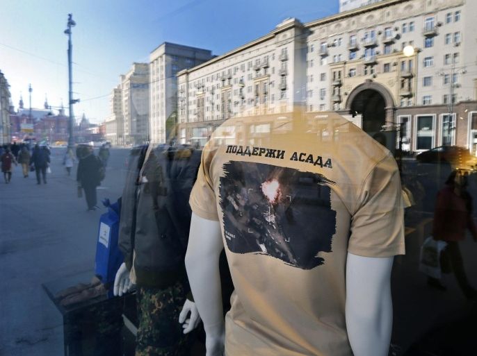 A mannequin is glimpsed through a shop window dressed in a T-shirt with an aerial view of Russian airsrikes in Syria and bearing the words reading in Russian 'Support Assad' at a Russian Army Store in downtown Moscow, Russia, 16 October 2015. Russia has increased its support of the al-Assad regime in Syria with airstrikes, criticised by some in the international community amid reports they disproportionately target opposition forces in the country instead of positions held by the group calling themselves the Islamic State (IS).