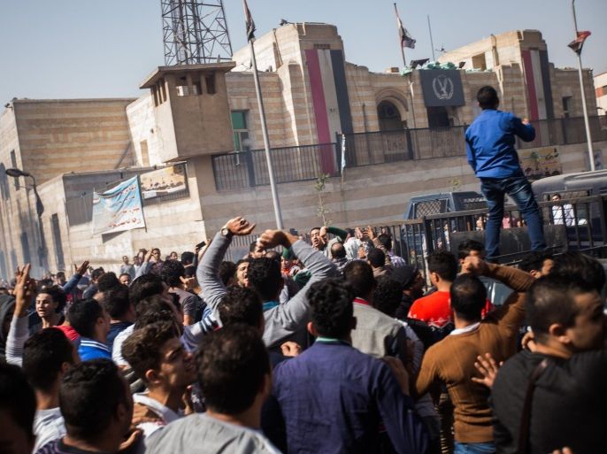 Mourners protest the death of Mohamed Ali, a 23 year-old driver, who was shot dead overnight during a dispute with a police sergeant, ouside local security headquarters in Cairo, Egypt, Friday, Feb. 19, 2016. Egypt's Interior Ministry media office said in a statement that the killing followed an argument over the sergeant's fare for his ride in Cairo's populous el-Darb el-Ahmar district. In the course of the dispute, the officer shot and killed the driver. (AP Photo/Belal Darder)