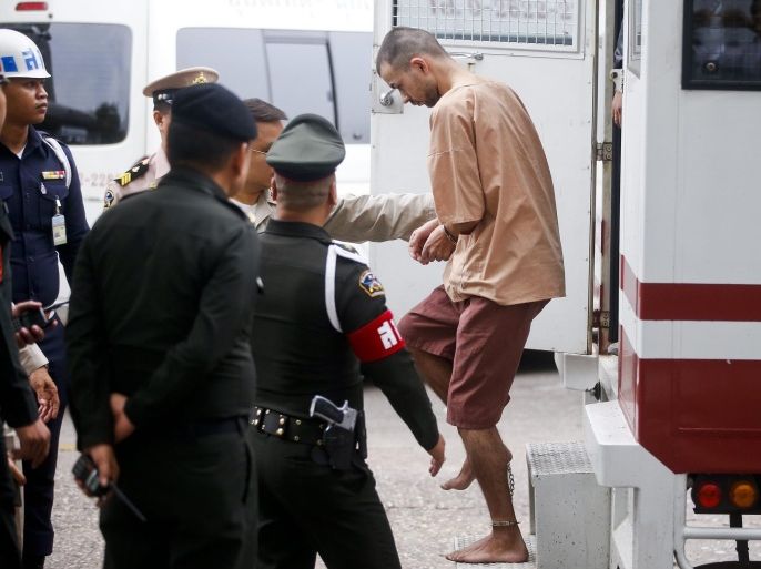 Erawan Shrine's bombing main suspect, identified by Thai police as Adem Karadag (R), exits the prison transport as he and Yusufu Mieraili (not in picture) arrive at the Military Court, in Bangkok, Thailand, 16 February 2016. A military court in Thailand on 24 November 2015, charged two men accused of carrying out a deadly explosion in central Bangkok in August. The bomb attack at a Hindu shrine killed 20 people, mostly tourists, and injured more than 120. Adem Karadag and Yusufu Mieraili each face 10 charges, including premeditated murder, but not terrorism, Thai media reported. The two suspects arrived at the military court in Bangkok on 16 February 2016, in handcuffs and escorted by the police. Karadag, identified initially by the name Bilal Muhammed, and Mieraili have been detained at an army base since they were arrested in August and September, respectively. Adem Karadag has retracted his confession of being involved in the attack claiming he was coerced into confessing, according to his lawyer Schoochart Kanpai.
