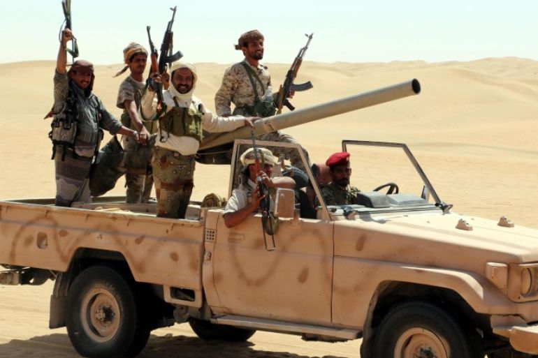 A photograph made available on 23 February 2016 shows pro-Yemeni government fighters riding a truck during a gathering in a desert area reportedly ahead of an offensive against al-Qaeda-held southern towns, in the eastern province of Shabwa, Yemen, 22 February 2016. According to reports, Al-Qaeda in the Arabian Peninsula (AQAP) has seized control of a coastal town in Yemen's southern Abyan province two days ago, the latest in a series of recent advances in the region that have enabled AQAP to consolidate its grip over much of Yemen's Gulf of Aden coastline.