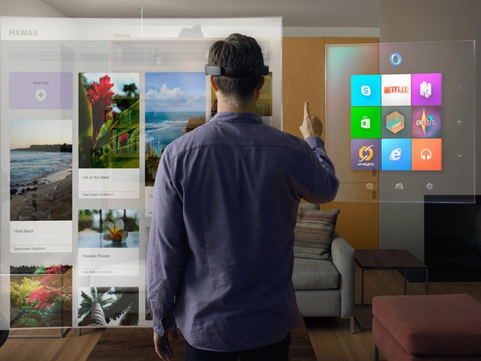 A model wears the Microsoft HoloLens as he scrolls through a virtual Windows menu in this publicity photo released to Reuters January 21, 2015. Microsoft Corp on Wednesday unveiled the holographic lens device that allows users to see three-dimensional renderings of computer-generated images. The device has no wires and looks like a visor. It ups the stakes in the emerging market for virtual reality, being targeted by Facebook Inc's Oculus. REUTERS/Microsoft Corp./Handout via Reuters (UNITED STATES - Tags: BUSINESS SCIENCE TECHNOLOGY) ATTENTION EDITORS - THIS PICTURE WAS PROVIDED BY A THIRD PARTY. REUTERS IS UNABLE TO INDEPENDENTLY VERIFY THE AUTHENTICITY, CONTENT, LOCATION OR DATE OF THIS IMAGE. FOR EDITORIAL USE ONLY. NOT FOR SALE FOR MARKETING OR ADVERTISING CAMPAIGNS. THIS PICTURE IS DISTRIBUTED EXACTLY AS RECEIVED BY REUTERS, AS A SERVICE TO CLIENTS. NO SALES. NO ARCHIVES