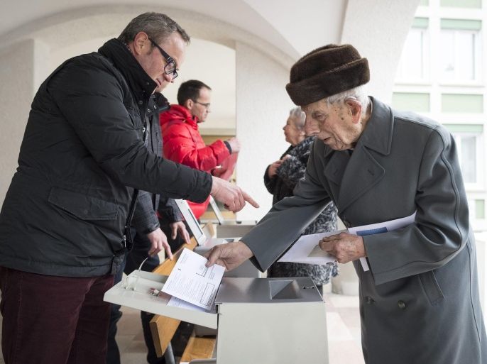 People cast their ballots at a election office in Appenzell, Switzerland, 28 February 2016. Swiss people vote on four initiatives this 28 February, among them a vote on a second the construction of a second road tunnel through the central Swiss Alps and the highly controversial initiative launched by Swiss People's Party SVP seeking to enforce the deportation of convicted foreigners ('Enforcement Initiative'). SVP drafted a broad list of minor and serious crimes that automatically result in extradition, including giving false testimony or carrying drugs.
