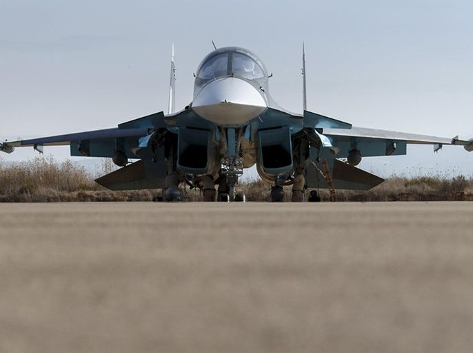Russian ground staff members work on a Sukhoi Su-34 fighter jet at the Hmeymim air base near Latakia, Syria, in this handout photograph released by Russia's Defence Ministry October 22, 2015. REUTERS/Ministry of Defence of the Russian Federation/Handout via Reuters ATTENTION EDITORS - THIS PICTURE WAS PROVIDED BY A THIRD PARTY. REUTERS IS UNABLE TO INDEPENDENTLY VERIFY THE AUTHENTICITY, CONTENT, LOCATION OR DATE OF THIS IMAGE. EDITORIAL USE ONLY. NOT FOR SALE FOR MARKETING OR ADVERTISING CAMPAIGNS. NO RESALES. NO ARCHIVE. THIS PICTURE IS DISTRIBUTED EXACTLY AS RECEIVED BY REUTERS, AS A SERVICE TO CLIENTS